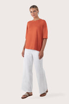 Side profile of the Yara Top Orange showing its cut and natural movement.