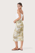 Side profile of the Zaree Linen Skirt The Island showing its cut and natural movement